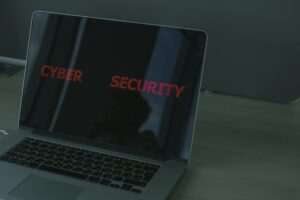 Close-up of a laptop displaying cybersecurity text, emphasizing digital security themes.